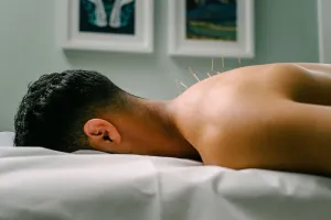 Neck and shoulder with needles in the back